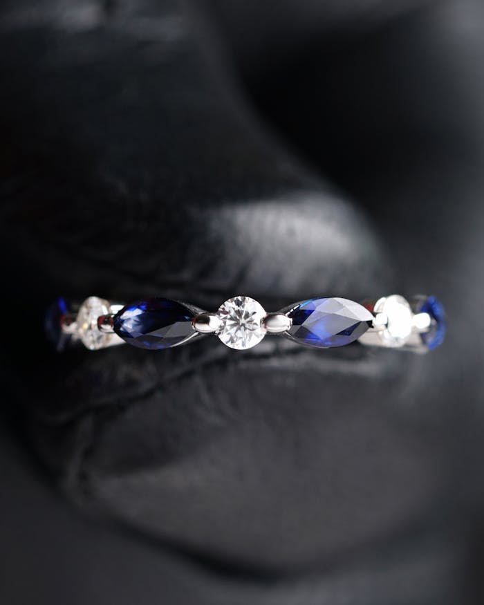Close-up of a sapphire and diamond ring showcasing luxury jewelry design.